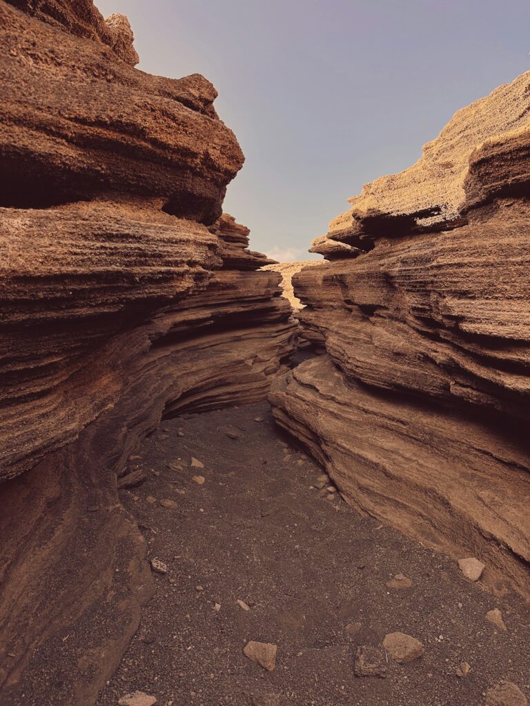 Narrow passage between striped rock walls at Las Grietas, Tías (Lanzarote)